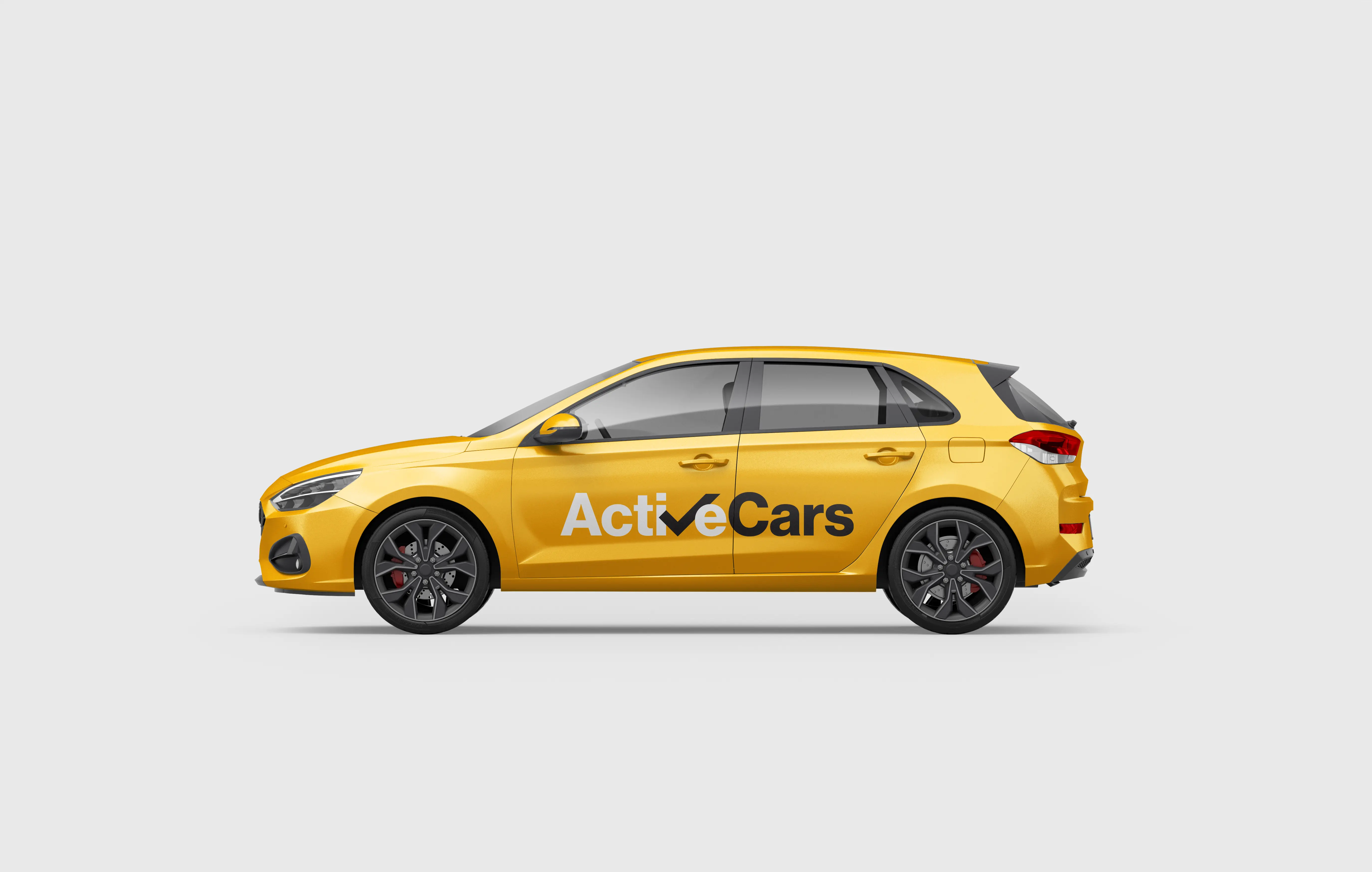 Yellow Active Cars taxi in side profile, showing the wordmark across the doors